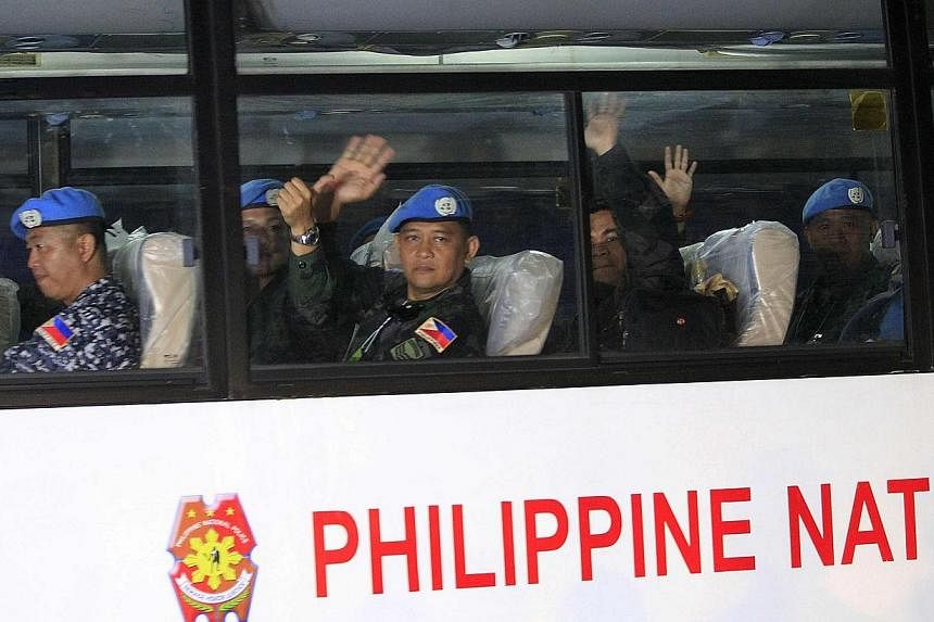The Philippines' top health and military officials were under fire on Tuesday for visiting Filipino United Nations troops undergoing quarantine after serving in Ebola-ravaged Liberia. -- PHOTO: REUTERS