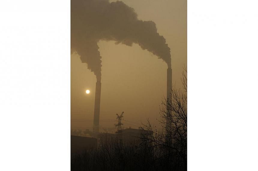 A file photo taken on Dec 8, 2009, shows smoke belching from a coal powered power plant on the outskirts of Linfen, in China's Shanxi province, regarded as one of the cities with the worst air pollution in the world.&nbsp;China needs to hit its "peak