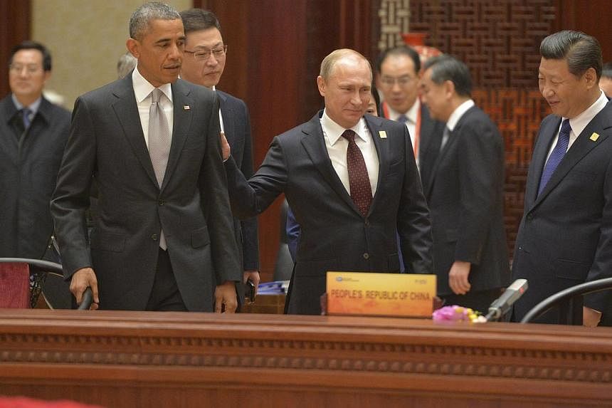 (From left) US President Barack Obama, Russian President Vladimir Putin and Chinese President Xi Jinping attend a plenary session during the Asia Pacific Economic Cooperation Summit in Beijing, on Nov 11, 2014. -- PHOTO: REUTERS