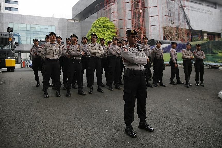 Indonesian police standing guard outside city hall during a small protest in Jakarta on Nov 17, 2014. The inauguration of Jakarta's first Christian governor in 50 years was postponed to next week to allow for a presidential decree on his appointment,