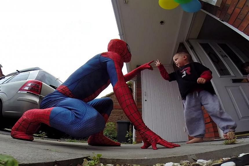 Mr Mike Wilson, dressed up as the boy's favourite action hero, Spider-Man, made a surprise appearance in front of their home and gave the boy a big hug.&nbsp;-- PHOTO: SCREENGRAB FROM YOUTUBE
