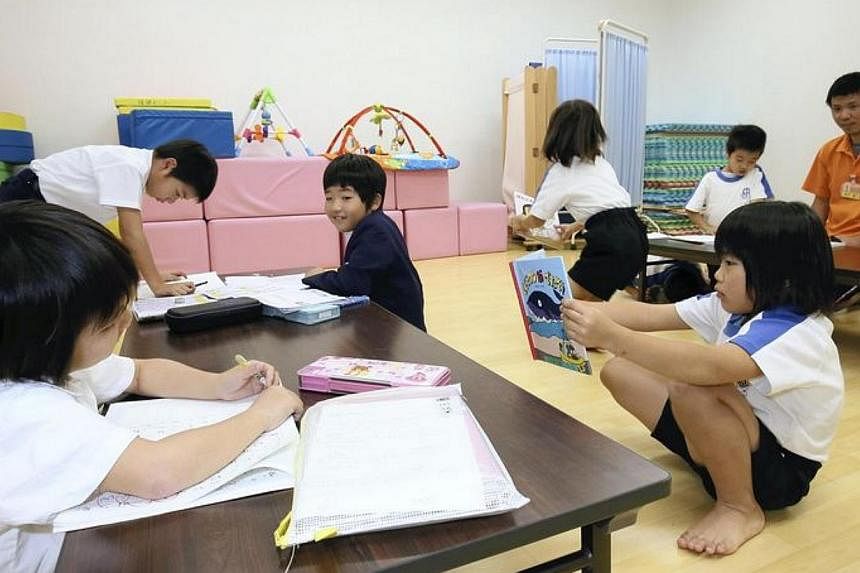 Children doing their homework at the Hokago Waku-waku Club (After-school fun club) in Isen, Kagoshima Prefecture, on Thursday, Nov 13, 2014. -- PHOTO: THE YOMIURI SHIMBUN/ASIA NEWS NETWORK