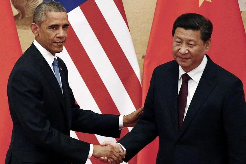 US President Barack Obama (left) and Chinese President Xi Jinping in Beijing on Nov 12, 2014. -- PHOTO: REUTERS