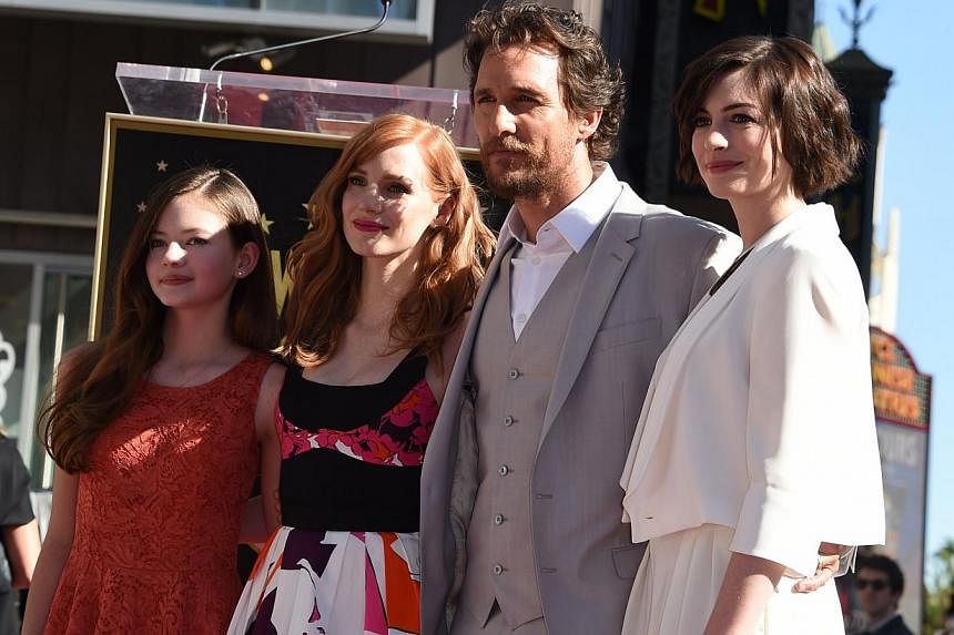 Actor Matthew McConaughey poses with actresses (from left) Mackenzie Foy, Jessica Chastain and Anne Hathaway during the ceremony honouring McConaughey with the 2,534th star on the Hollywood Walk of Fame in Hollywood, California, on Nov 17, 2014. -- P