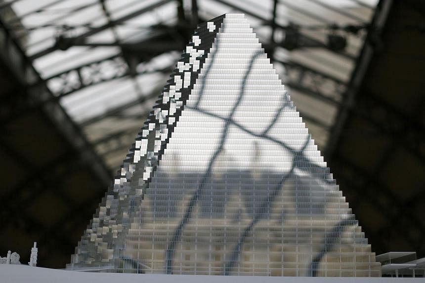 A model of the Tour Triangle, a proposed skyscraper designed by Swiss agency Herzog &amp; de Meuron, is displayed at the Paris Center for architecture and urbanism center The Pavillon de l'Arsenal in Paris, on Nov 17, 2014. -- PHOTO: REUTERS