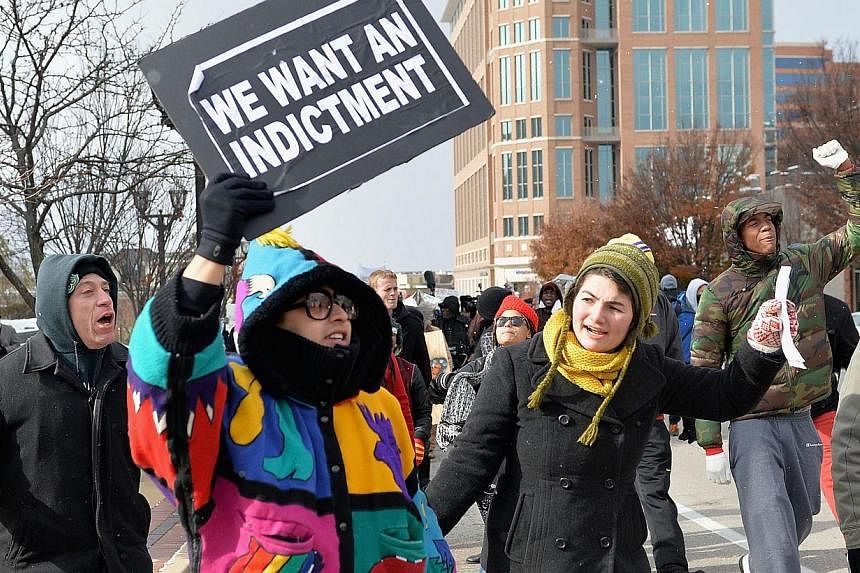 Protesters march in a peaceful protest on Nov 17, 2014 streets in Clayton, Missouri. The governor of the US state of Missouri declared a state of emergency on Monday and activated the National Guard ahead of a grand jury decision in the case of a bla