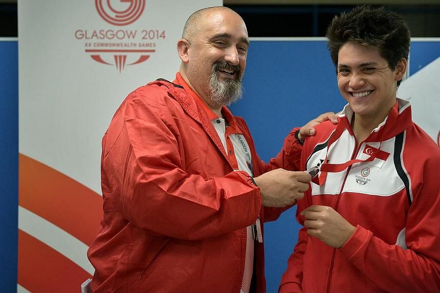 Joseph Schooling (right) celebrating his silver-medal achievement in the 100m butterfly event with his coach Sergio Lopez at the Tollcross International Swimming Centre on July 28, 2014. Mr Lopez is set to take over as head coach of the national swim