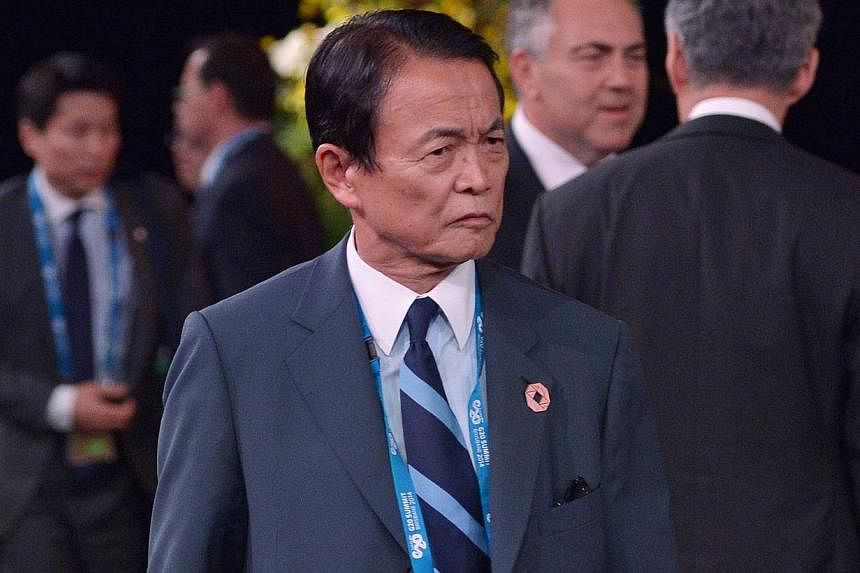 Japan's Deptuty Prime Minister and Finance Minister Taro Aso arriving for the welcome country performance at the Brisbane Convention and Exhibition Center on Nov 15, 2014 in Brisbane, Australia. Mr Aso said on Tuesday that raising the sales tax is un