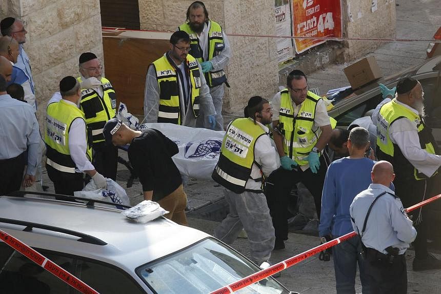 Israeli police said on Tuesday that three of the people killed by Palestinian attackers in a Jerusalem synagogue were dual US-Israeli nationals and the fourth man held British and Israeli citizenship. -- PHOTO: AFP