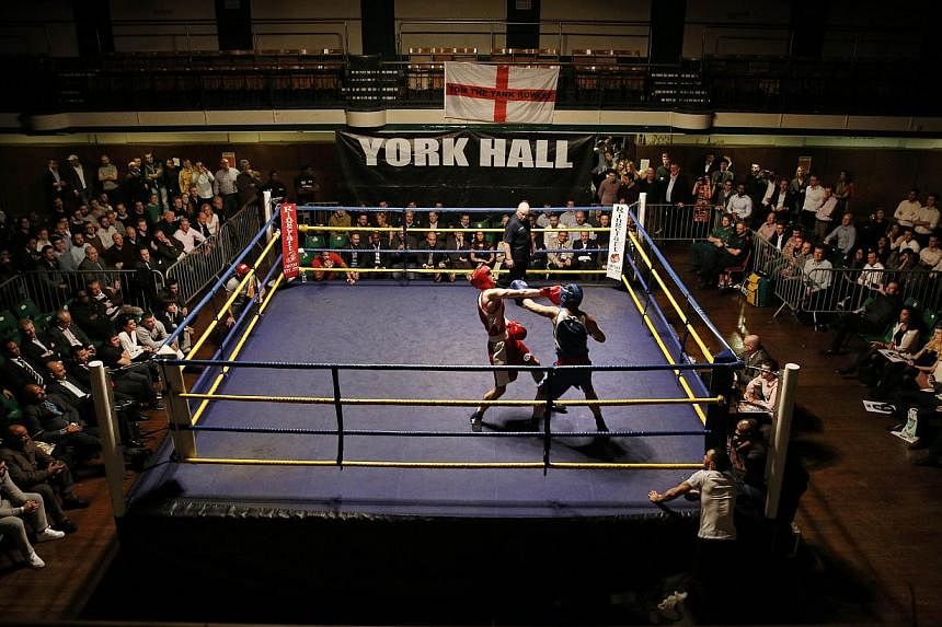A bout during the "Brawl at the Hall" white-collar boxing event at York Hall in Bethnal Green, London.&nbsp;-- PHOTO: AFP