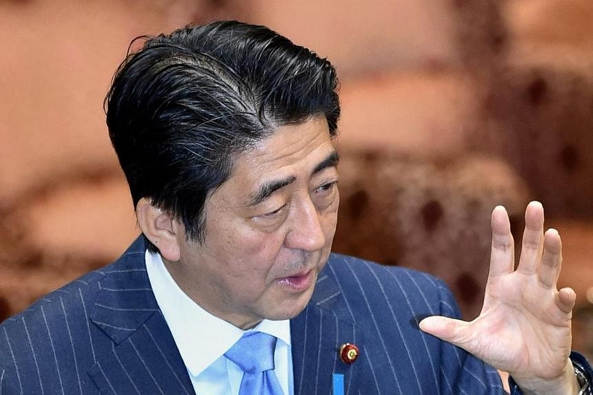 Japan's Prime Minister Shinzo Abe answers questions during an Upper House special committee session in Parliament in Tokyo on Nov 19, 2014.&nbsp;-- PHOTO: AFP