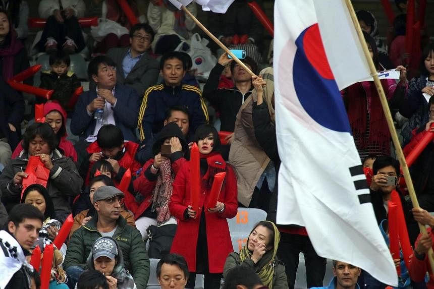 South Korean fans watch an friendly football match between Iran and South Korea at the Azadi stadium in Teheran on Nov 18, 2014.&nbsp;Iran's controversial 1-0 win ended with players, coaches and officials having to be pulled apart by cooler heads, wi