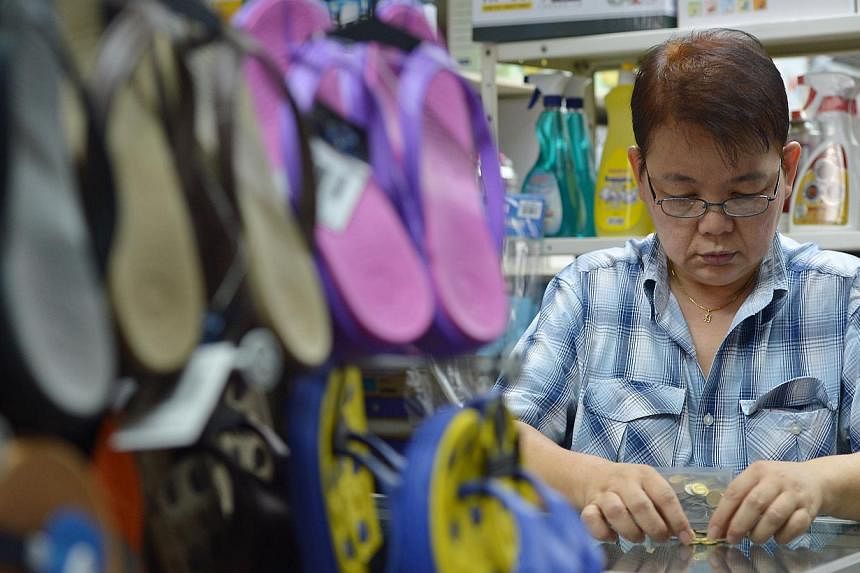 Madam Koh Hong Cheng of Tung Kuang Trading and Refrigerator Service says she never rejects coins. While heartland firms welcome coin payments, five-cent coins are out as customers are unwilling to take them as change.