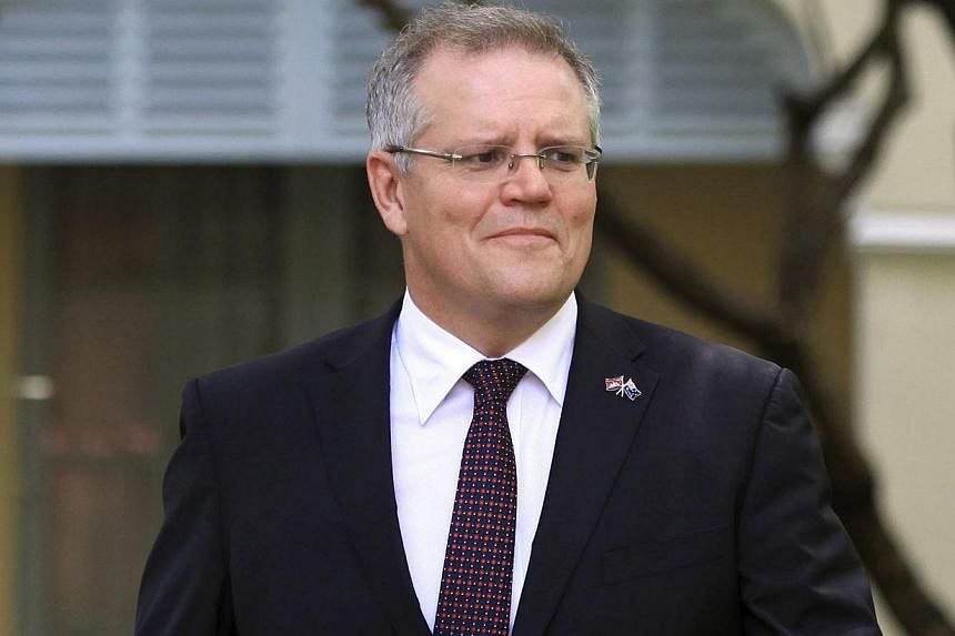 Australia's Immigration Minister Scott Morrison leaves after an interview with Reuters in Phnom Penh on Sept 26, 2014. Mr Morrison on Wednesday said he was "taking the sugar off the table" in announcing that Canberra was slamming the door on United N
