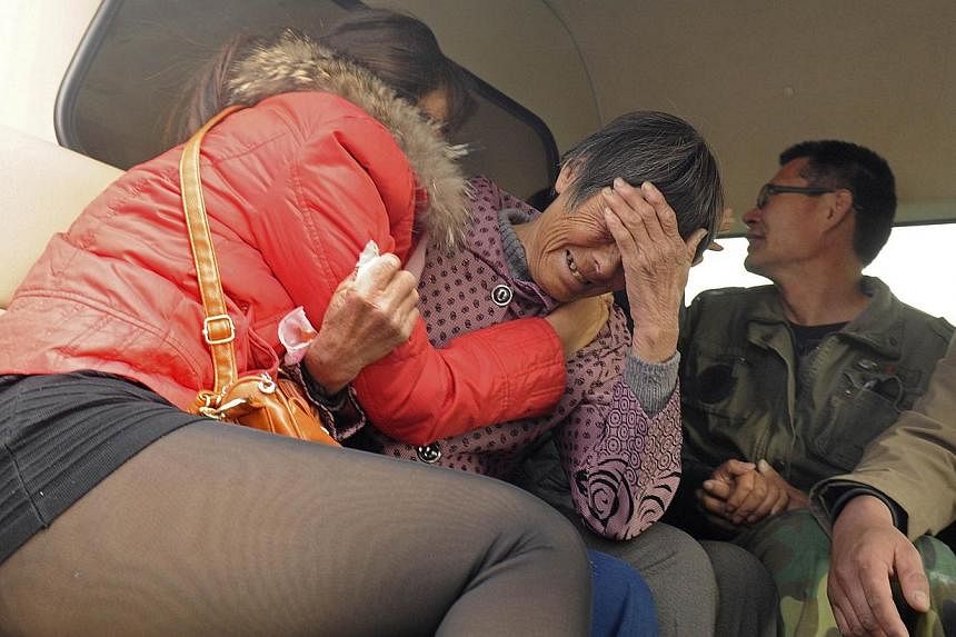 Relatives of kindergarten children, who died after the van they were travelling in ran into a truck, cry in Penglai, Shandong province on Nov 19, 2014. -- PHOTO: REUTERS