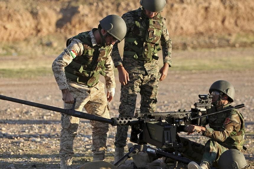 Kurdish peshmerga fighters undergo training by British soldiers at a shooting range in Arbil, in Iraq's northern autonomous Kurdistan region. The president of Iraqi Kurdistan accused Western countries on Wednesday of not providing enough heavy weapon