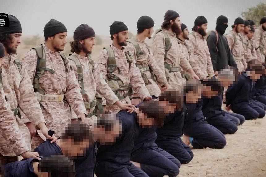 An still taken from a propaganda video released on Nov 16, 2014 by al-Furqan Media allegedly shows members of the Islamic State jihadist group preparing the simultaneous beheadings of men described as Syrian military personnel. -- PHOTO: AFP/ HO/ AL-