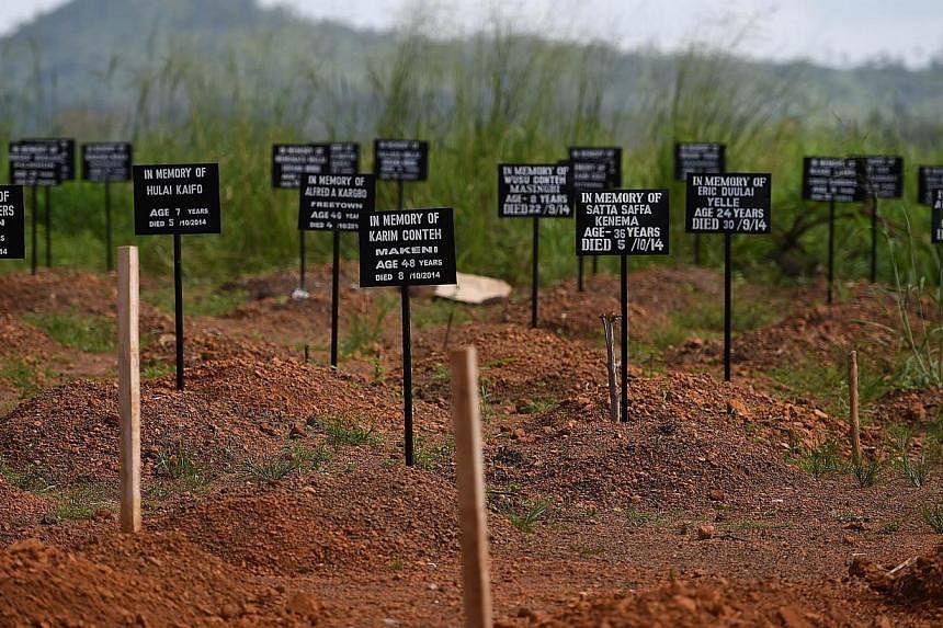 Tombstones are seen at a cemetery at the Kenama ebola treatment centre run by the Red cross Society on Nov 15, 2014. -- PHOTO: AFP