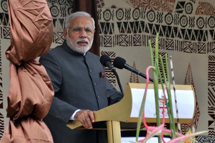 India's Prime Minister Narendra Modi speaks following a traditional welcoming ceremony at Albert Park in Suva on Nov 19, 2014. Mr Modi on Wednesday pledged a multimillion dollar line of credit for Fiji's struggling sugar industry, once worked by thou