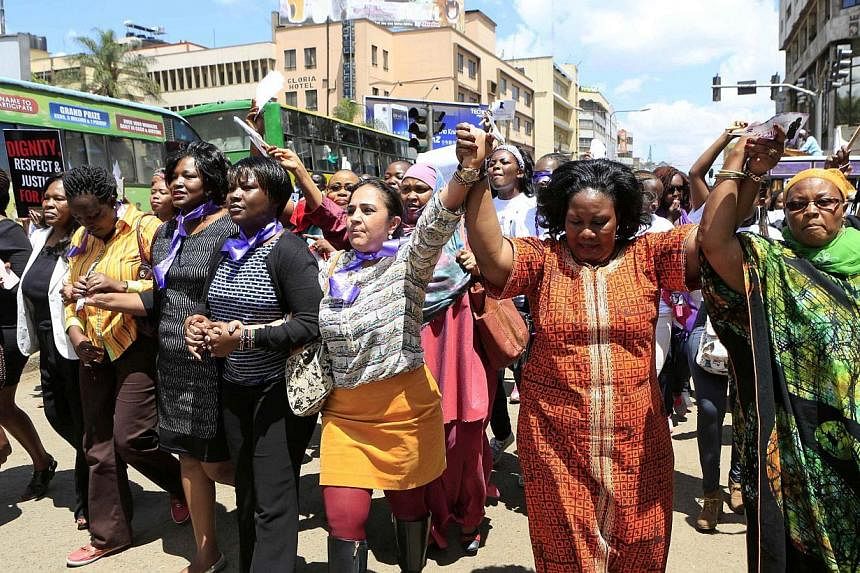Women take part in a protest along a main street in the Kenyan capital of Nairobi Nov 17, 2014. The demonstrators were demanding justice for a woman who was attacked and stripped recently in Nairobi by men who claimed that she was dressed indecently.