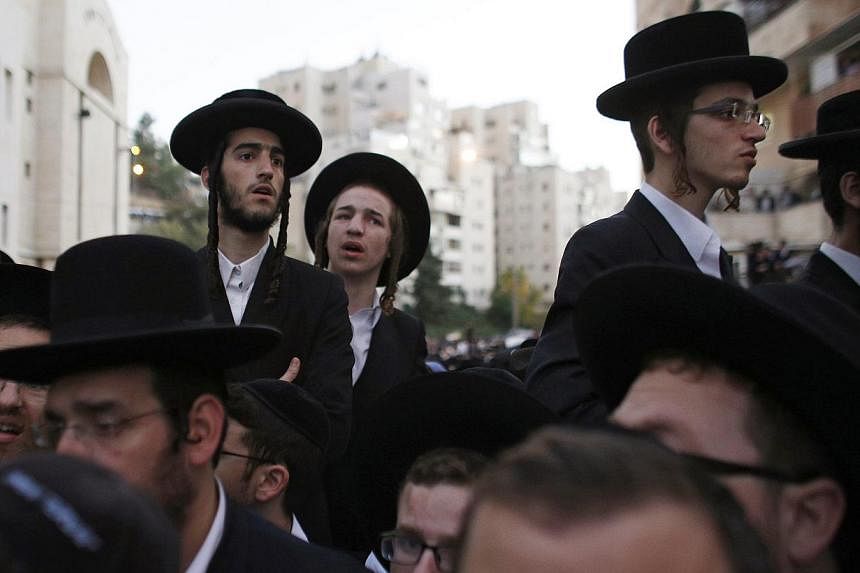 Israeli ultra-orthodox Jews attend the funeral of Mr &nbsp;Aryeh Kupinsky, Mr Kalman Levine and Mr Avraham Goldberg in Jerusalem on Nov 18, 2014. -- PHOTO: REUTERS