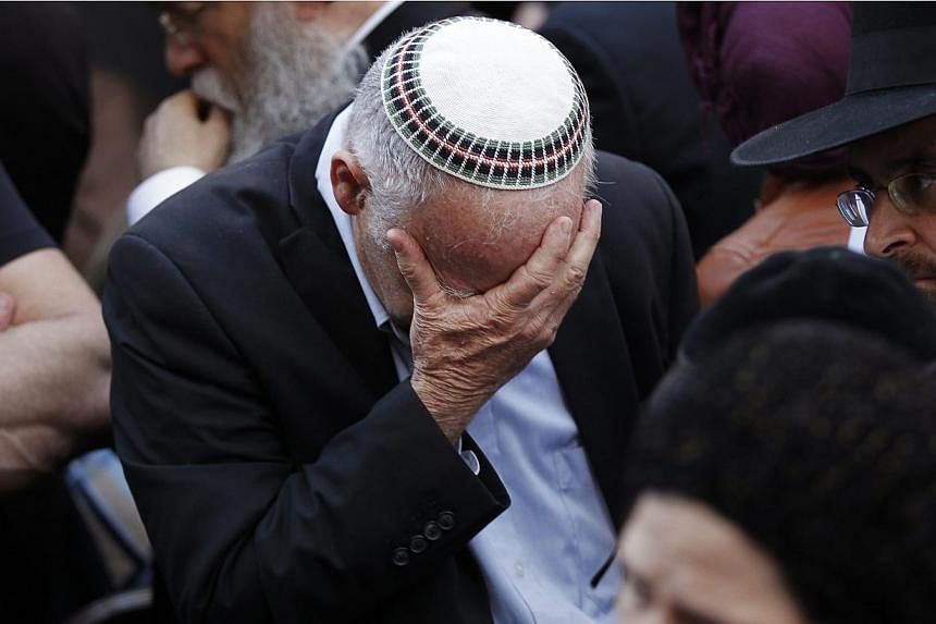 An Israeli mourns during the funeral of some of the victims of the&nbsp;synagogue attack&nbsp;in Jerusalem on Nov 18, 2014. -- PHOTO: REUTERS