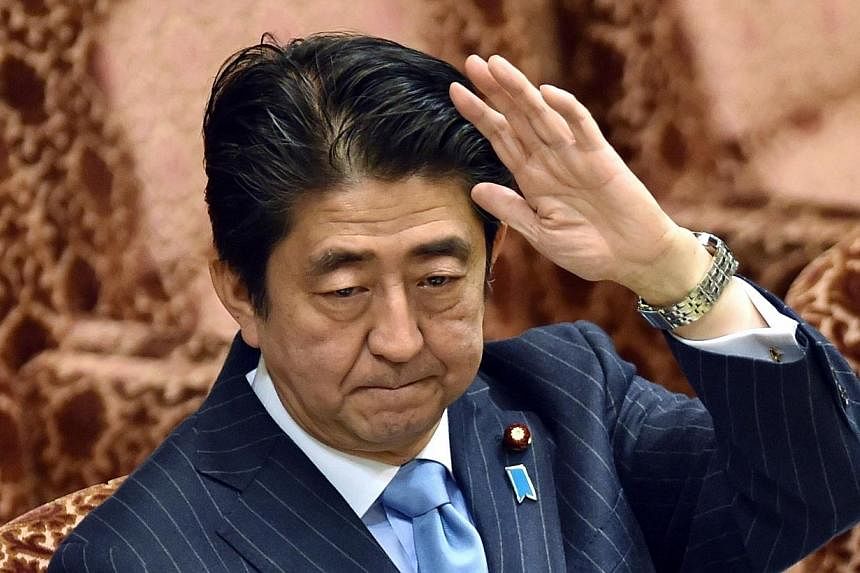 Japan's Prime Minister Shinzo Abe raises his hand to answer questions during an Upper House special committee session at the parliament in Tokyo on Nov 19, 2014.&nbsp;Nearly two-thirds of Japanese voters don't understand why Prime Minister Shinzo Abe