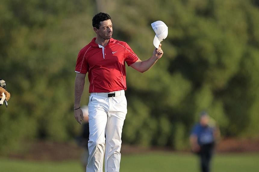 Rory McIlroy of Northern Ireland waves on the 18th green during the first round of the DP World Tour Championship in Dubai on Nov 20, 2014.&nbsp;Rory McIlroy rattled in six birdies in an opening round six-under 66 at the DP World Tour Championship on
