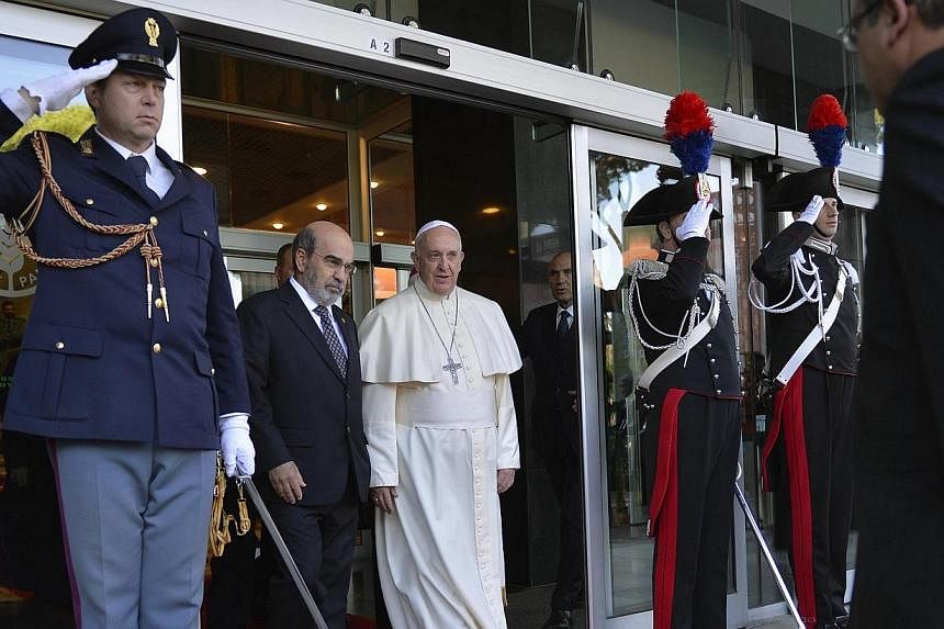 Pope Francis walks with UN Food and Agriculture Organization (FAO) Director-General Jose Graziano da Silva as he leaves at the end of a meeting at the FAO headquarters in Rome on Nov 20, 2014.&nbsp;Pope Francis condemned speculation in food commoditi