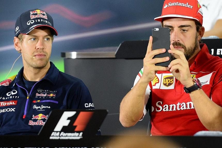 Ferrari confirmed on Thursday that&nbsp;four times world champion&nbsp;Sebastian Vettel (left)&nbsp;would replace Fernando Alonso next season on a three-year deal. -- PHOTO: AFP