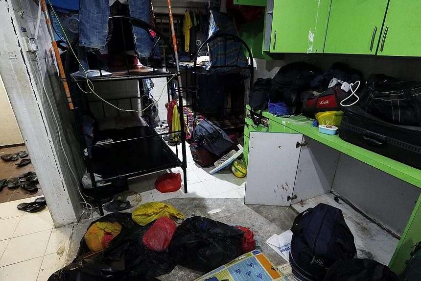 In two condo units in Selegie Centre, about 50 workers live out of their luggage amid damp and soiled clothes, and sleep on grimy floors without mattresses or in bunk beds crammed together.