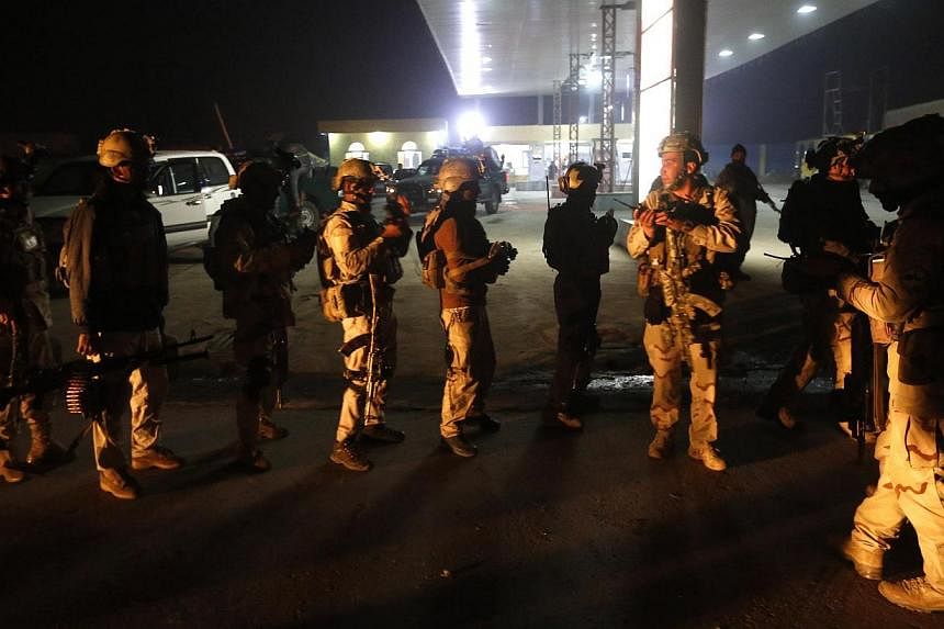 Afghan security forces arrive at the site of a Taliban assault in Kabul Nov 19, 2014. Four Afghan Taliban suicide bombers died when a group of the militants tried to storm an international zone in Kabul on Wednesday in the latest high-profile assault