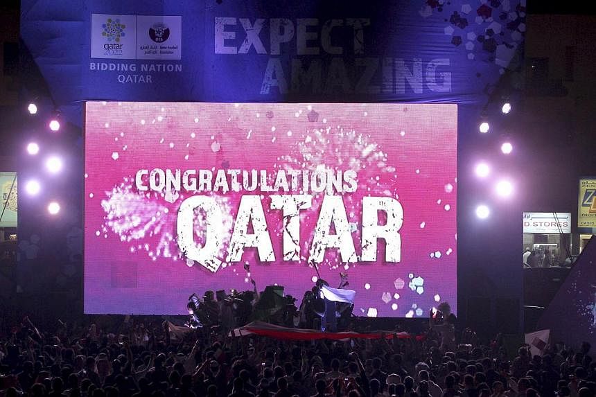 People celebrate in front of a screen that reads "Congratulations Qatar" after Fifa announced that Qatar will be host of the 2022 World Cup in Souq Waqif in Doha on Dec 2, 2010. Ms Phaedra Almajid, a whistleblower who gave evidence of corruption agai