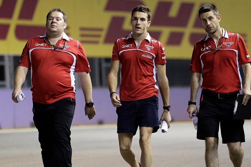 Formula One driver Jules Bianchi of France (centre) and crew members walk on the the Marina Bay street circuit ahead of the Singapore F1 Grand Prix in Singapore Sept 18, 2014. Bianchi&nbsp;suffered the most serious F1 race injury since Ayrton Senna d