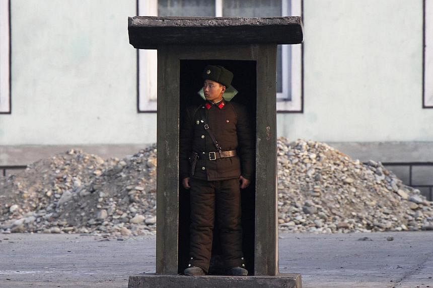A soldier stands guard at a sentry on the banks of the Yalu River, near the North Korean town of Sinuiju, opposite the Chinese border city of Dandong, on Nov 15, 2014. New satellite imagery suggests North Korea may be firing up a facility for process