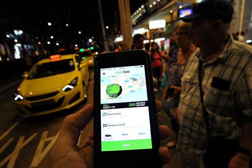 Third-party taxi booking services like GrabTaxi (pictured) and Uber will soon be regulated by the Land Transport Authority (LTA). -- PHOTO: LIM YAOHUI FOR THE STRAITS TIMES