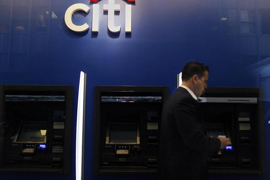 A man walking past a Citibank branch in lower Manhattan, New York in this file photo from Oct 16, 2012. The global head of Citigroup's environmental and social risk management was found dead in his New York apartment on Tuesday with his throat cut an