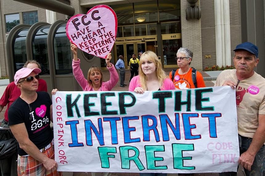 Protesters hold a rally to support net neutrality and urge the Federal Communications Commission (FCC) to reject a proposal that would allow Internet service providers such as AT&amp;T and Verizon "to boost their revenue by creating speedy online lan