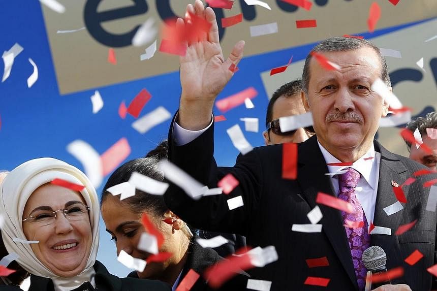 Turkey's President Tayyip Erdogan, accompanied by his wife Emine Erdogan, attends the opening ceremony of an imam-hatip school in Ankara on Nov 18, 2014.&nbsp;Turkey's top religious body said on Friday that there are plans to build a mosque in every 