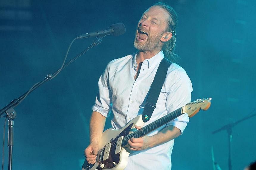 A July 10, 2012 file photo showing Radiohead singer-songwriter Thom Yorke performing in Nimes, France. The rock band is in the early stages of working on a new album, its first since 2011. -- PHOTO: AFP