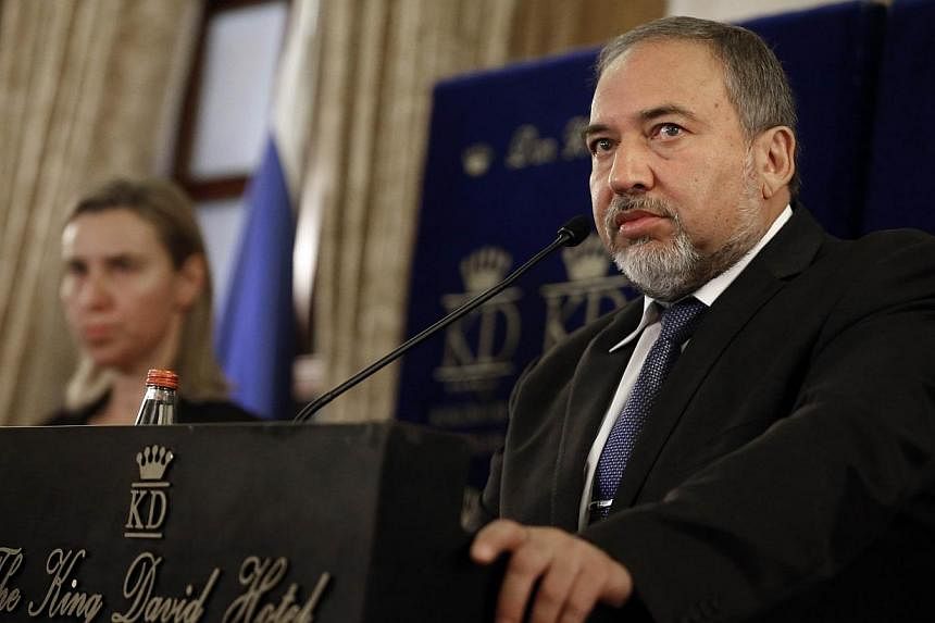 Israeli Foreign minister Avigdor Lieberman responds to journalist questions during a joint press conference with new High Representative of the European Union (EU) for Foreign Affairs and Security Policy, Federica Mogherini (left) in a hotel, downtow
