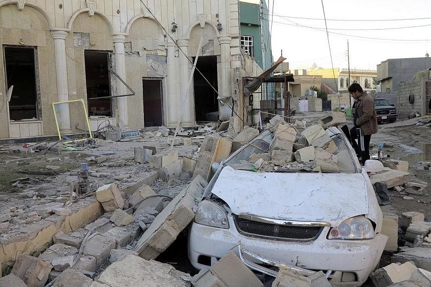 A damaged car is seen after a bombing in the city of Ramadi, west of Baghdad on Nov 6, 2014. -- PHOTO: REUTERS