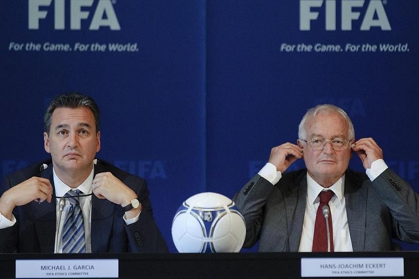 A file picture taken on July 27, 2012, showing chief investigator Michael Garcia (left) and German judge Hans-Joachim Eckert at a media conference at the Fifa headquarters in Zurich. The The two have been at loggerheads over how much of the report on