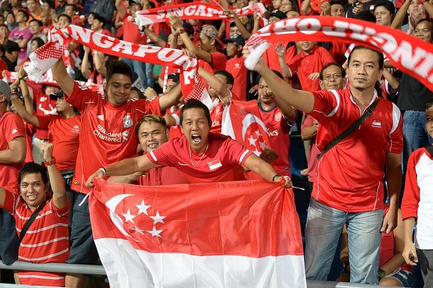 Singapore fans showing their support for the Lions during the first-leg final match of the Asean Football Federation (AFF) Suzuki Cup 2012 at the Jalan Besar Stadium on Dec 19, &nbsp;2012. -- PHOTO: ST FILE