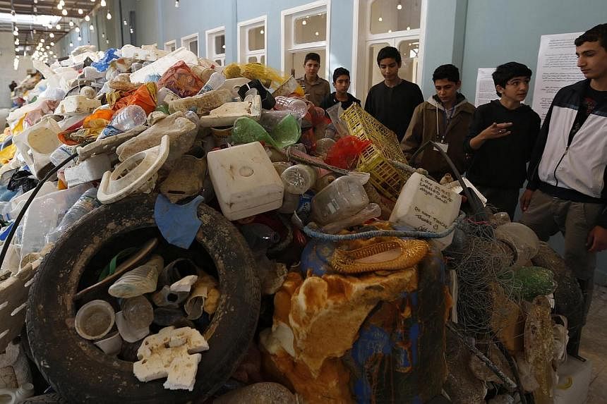 Jordanian students tour the plastic waste exhibition Sea, The Last Leg in downtown Amman Nov 19, 2014.&nbsp;EU governments unanimously approved a new law to slash the use of plastic grocery bags on Friday, hoping to curb litter on land and a spreadin
