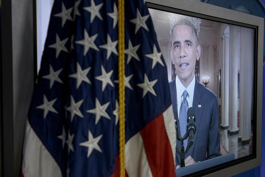 US President Barack Obama is seen on a screen in the White House briefing room during an address to the nation on immigration reform Nov 20, 2014 in Washington, DC. Obama will travel to India in January for its Republic Day celebrations, and talks wi
