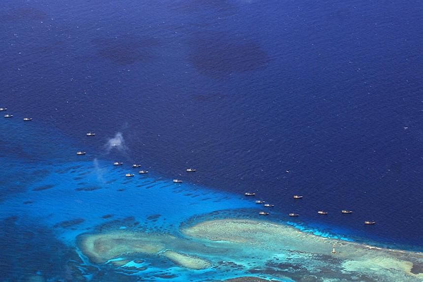 This handout file photo taken on July 17, 2012 and released by the Philippine military's Western Command shows Chinese fishing vessels anchored at Fiery Cross Reef (Kagitingan) on the disputed Spratly islands. -- PHOTO: AFP