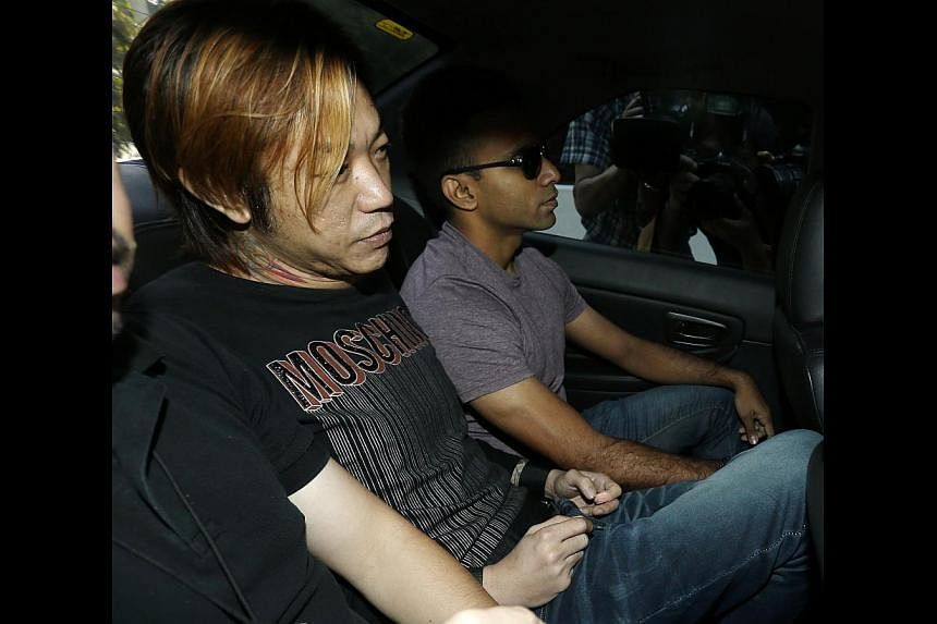 Lim Hou Peng Jackson, 40, was charged in court with the murder of Vietnamese woman Tran Cam Ny, 32, in an Ang Mo Kio flat. -- ST PHOTO: WONG KWAI CHOW