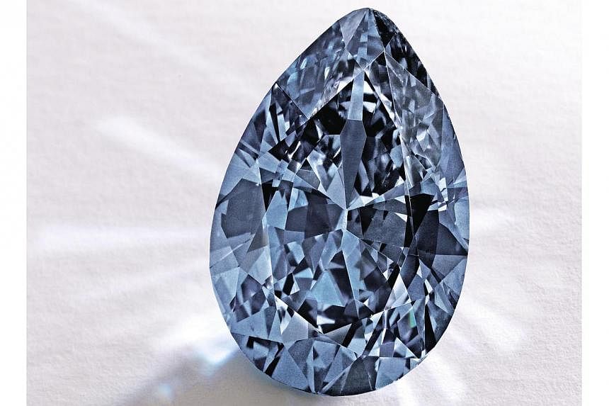 A magnificent blue diamond (above) has fetched US$32.6 million (S$42.3 million) in New York, breaking the world auction record for any diamond of its colour, auction house Sotheby's announced. -- PHOTO: AFP