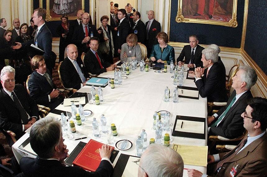 French Foreign Minister Laurent Fabius (third left), EU envoy Catherine Ashton (sixth left), US Secretary of State John Kerry (third right) and Britain's Foreign Secretary Philip Hammond (front left) sit at a table during talks in Vienna Nov 21, 2014